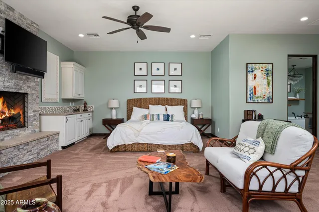 a bedroom with a bed and a flat screen tv