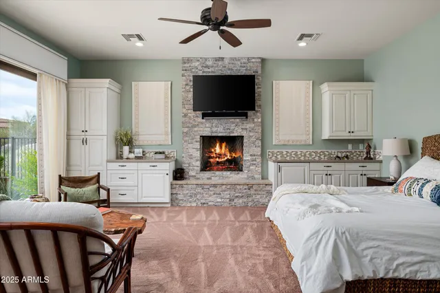 a bedroom with a bed and a fireplace