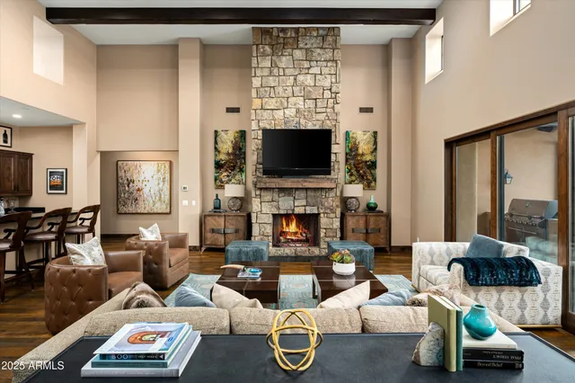 a living room with furniture a flat screen tv and a fireplace