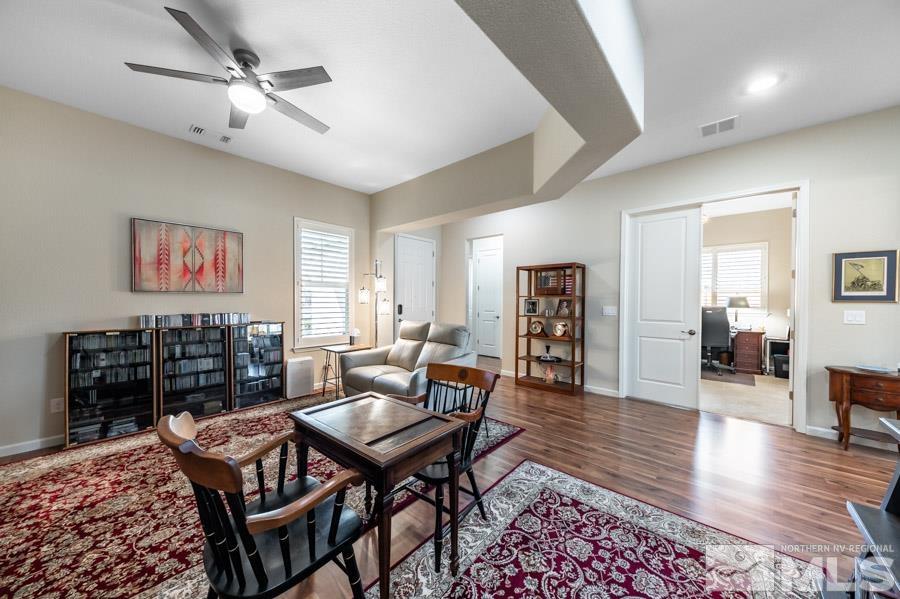 950 Broderick Trail Reno, NV 89523 - Photo 11 of 39 a dining room with wooden floor a chandelier fan a glass table and chairs