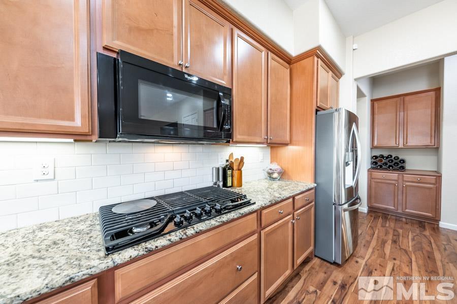 950 Broderick Trail Reno, NV 89523 - Photo 14 of 39 a kitchen with stainless steel appliances granite countertop a stove a sink and a microwave