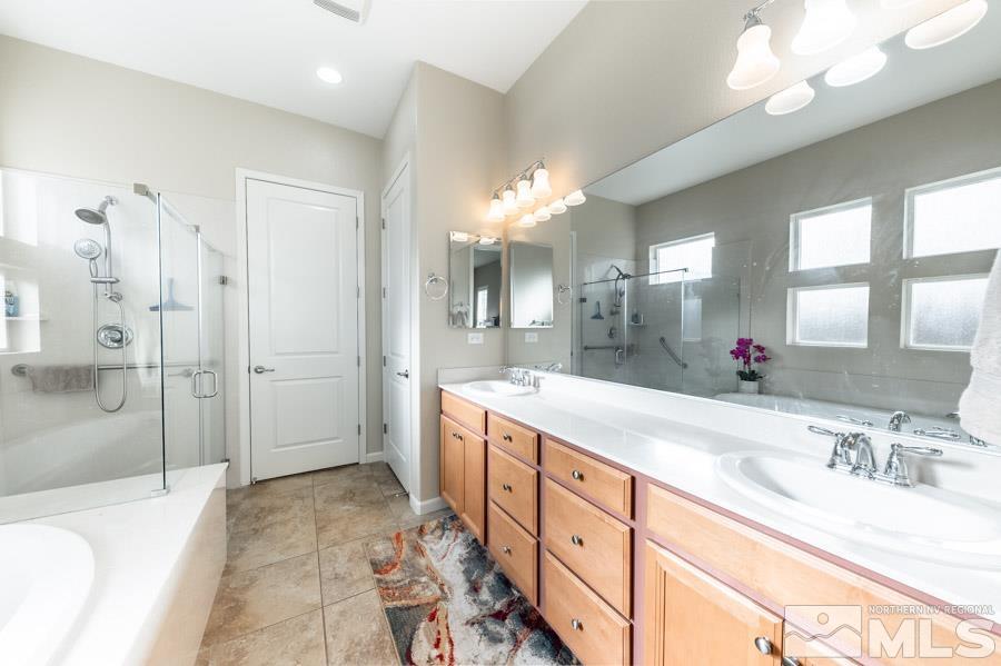 950 Broderick Trail Reno, NV 89523 - Photo 23 of 39 a spacious bathroom with a granite countertop double vanity sink mirror and shower