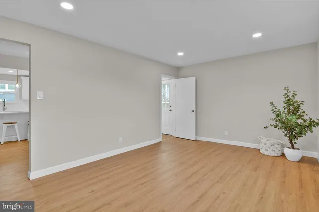 a view of an empty room with wooden floor
