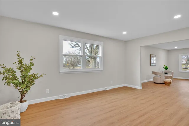 a view of livingroom with hardwood floor and a potted plant