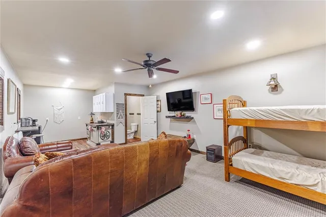 a bedroom with furniture and a flat screen tv