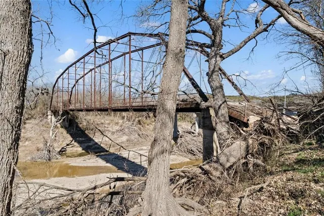 a view of a backyard with wooden fence