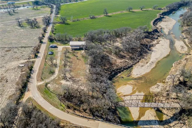 an aerial view of a house with a yard