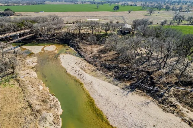 a view of a lake with beach and outdoor space