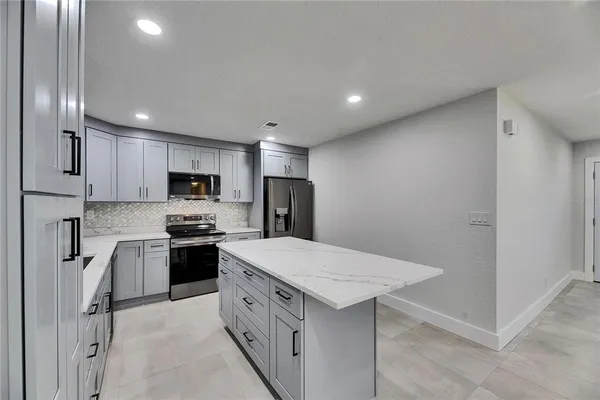 a kitchen with stainless steel appliances a refrigerator sink and stove