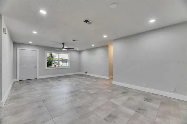 a view of kitchen with stainless steel appliances granite countertop a sink and a refrigerator
