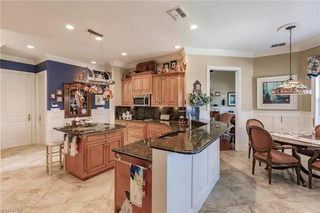a kitchen with sink refrigerator and cabinets