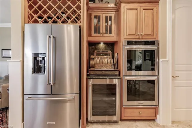a kitchen with stainless steel appliances and refrigerator