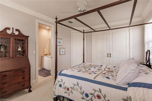 a bedroom with a bed and a dresser in it