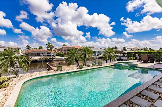 a view of a swimming pool with a table and chairs