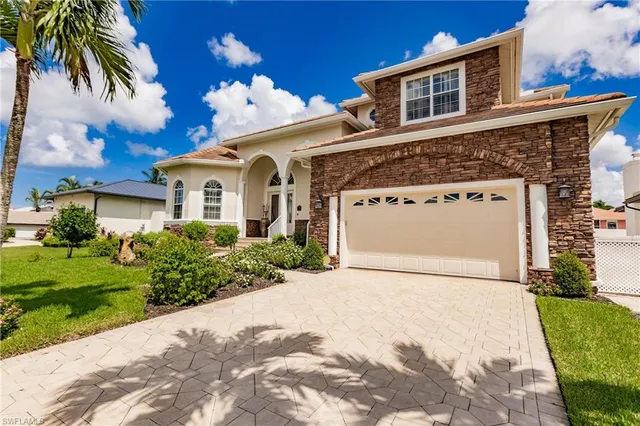 a front view of a house with a yard and garage
