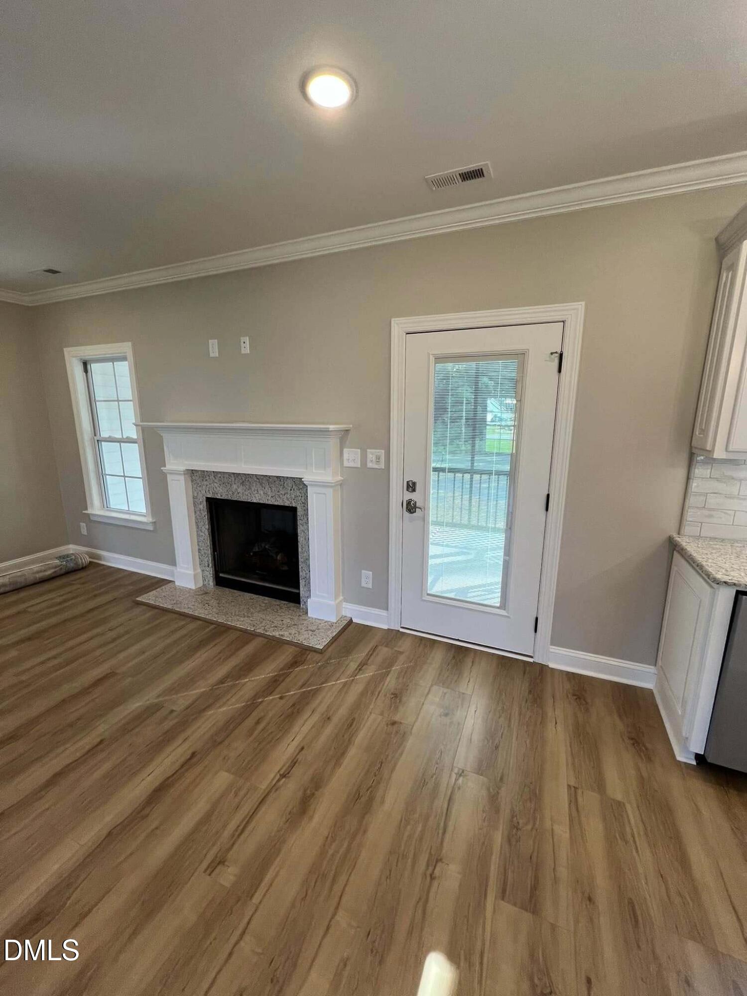 10 H Good Shepherd Trail Spring Spring Hope, NC 27882 - Photo 12 of 34 a view of an empty room with wooden floor and a window
