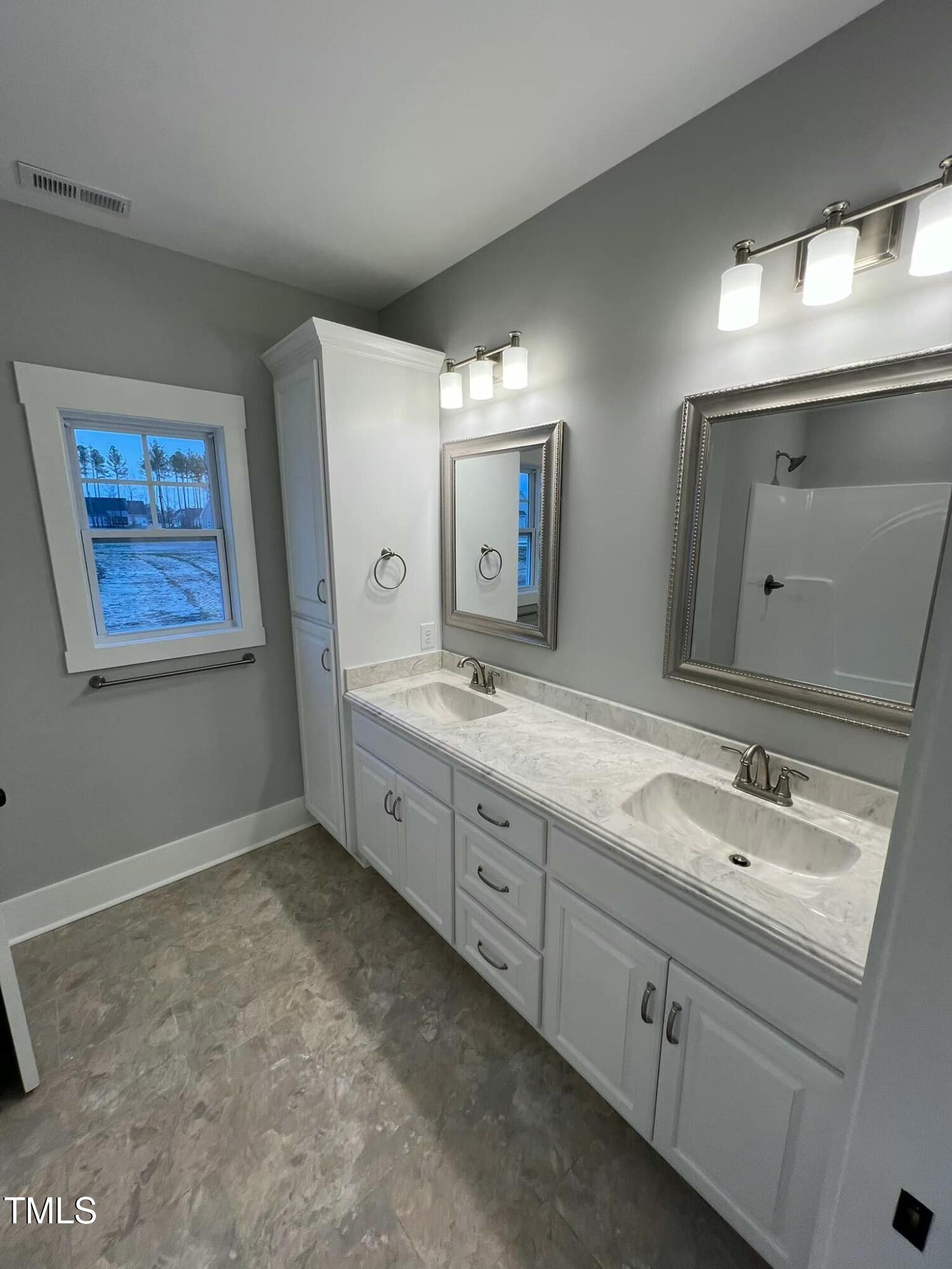 10 H Good Shepherd Trail Spring Spring Hope, NC 27882 - Photo 19 of 34 a spacious bathroom with a double vanity sink and a mirror