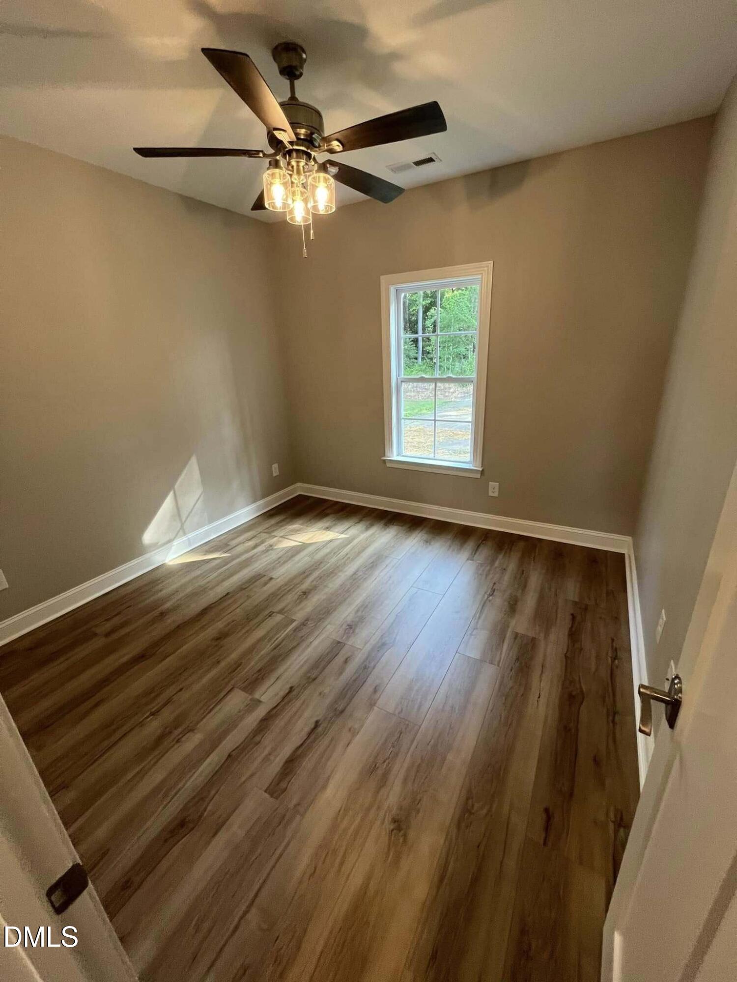 10 H Good Shepherd Trail Spring Spring Hope, NC 27882 - Photo 25 of 34 a view of an empty room with wooden floor and a window
