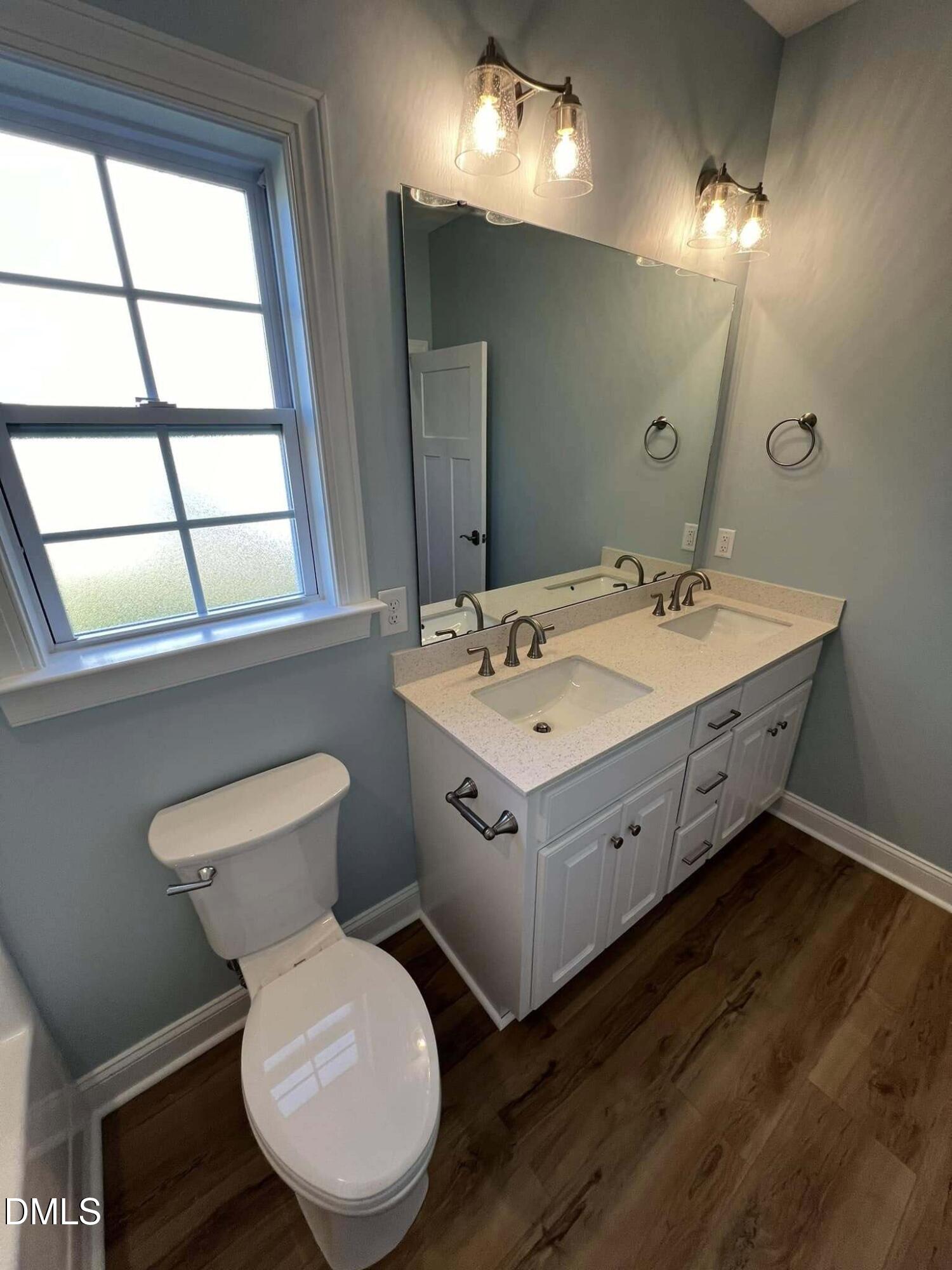 10 H Good Shepherd Trail Spring Spring Hope, NC 27882 - Photo 27 of 34 a bathroom with a double vanity sink toilet and a mirror