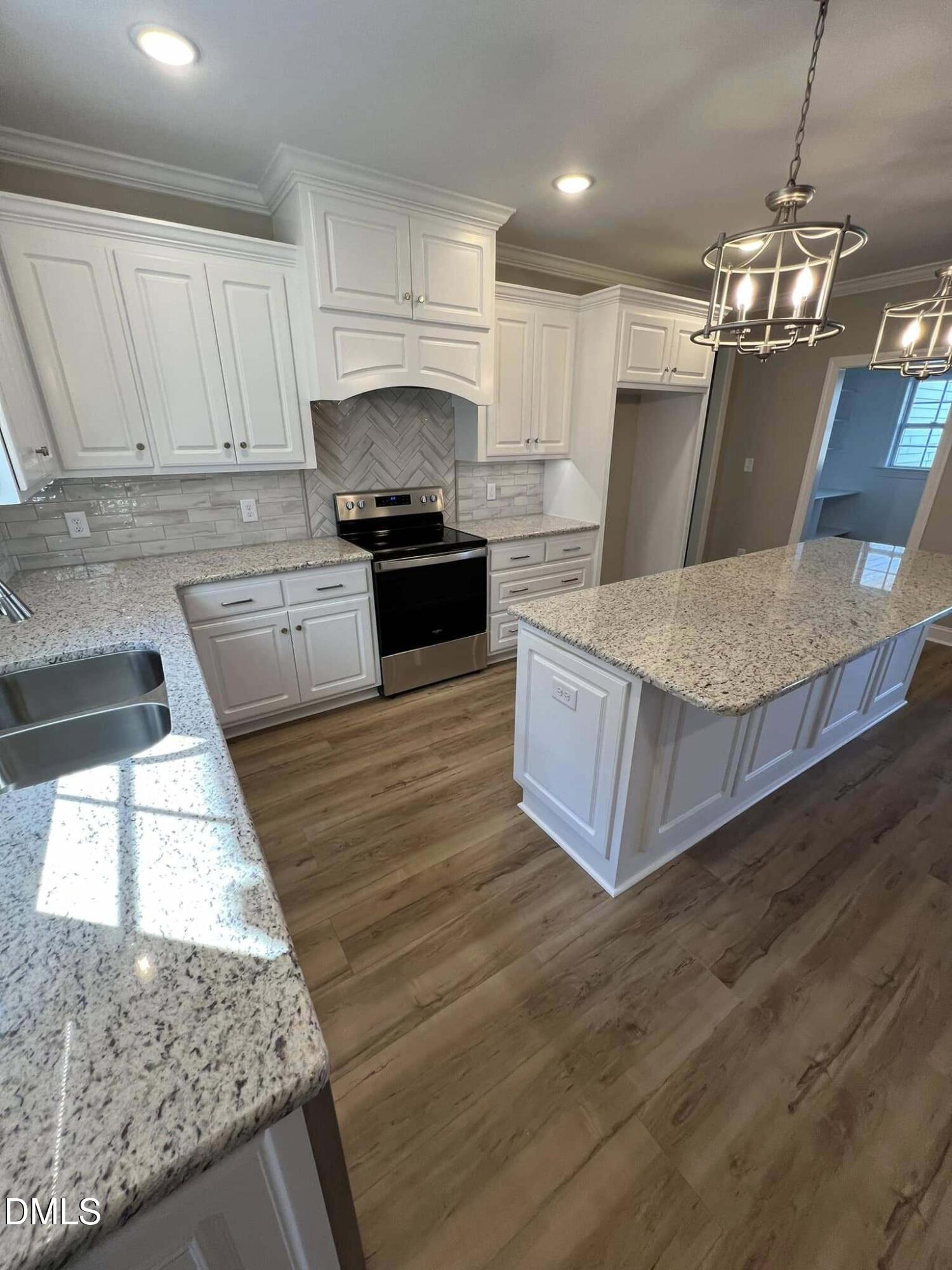 10 H Good Shepherd Trail Spring Spring Hope, NC 27882 - Photo 9 of 34 a kitchen with stainless steel appliances granite countertop a sink a stove a microwave a counter top and cabinets