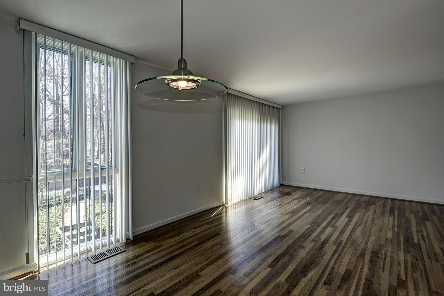 7942 Inverness Ridge Road Potomac, MD 20854 - Photo 8 of 24 a view of an empty room with wooden floor and a window