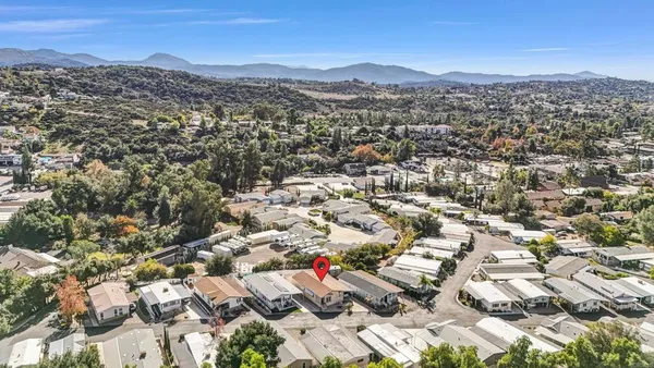 an aerial view of residential houses with city view