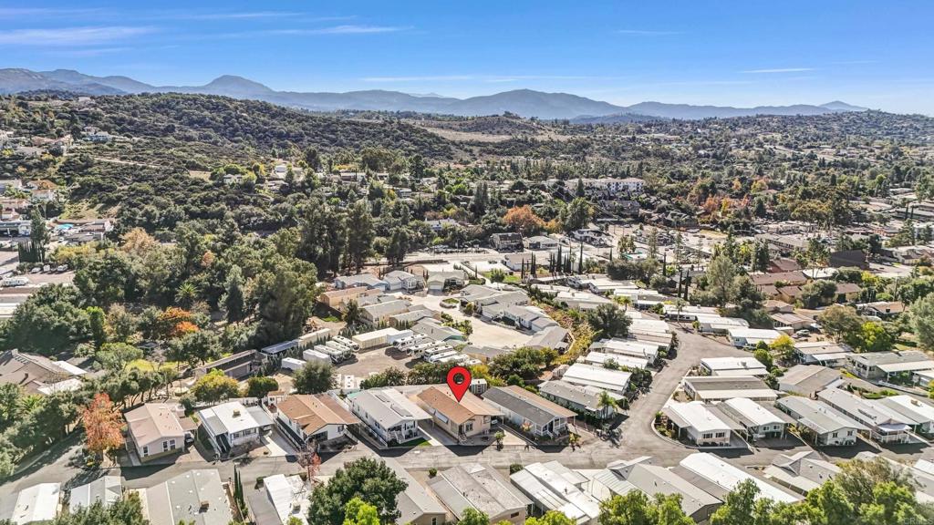 an aerial view of residential houses with city view