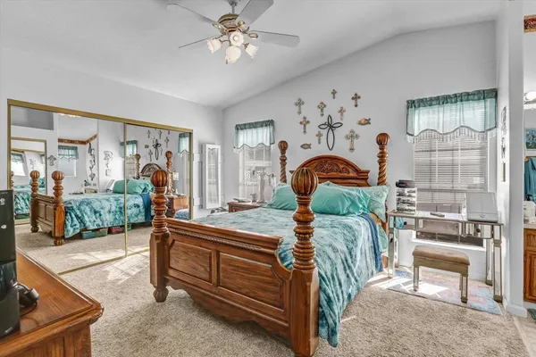 a bedroom with furniture a bed and a chandelier