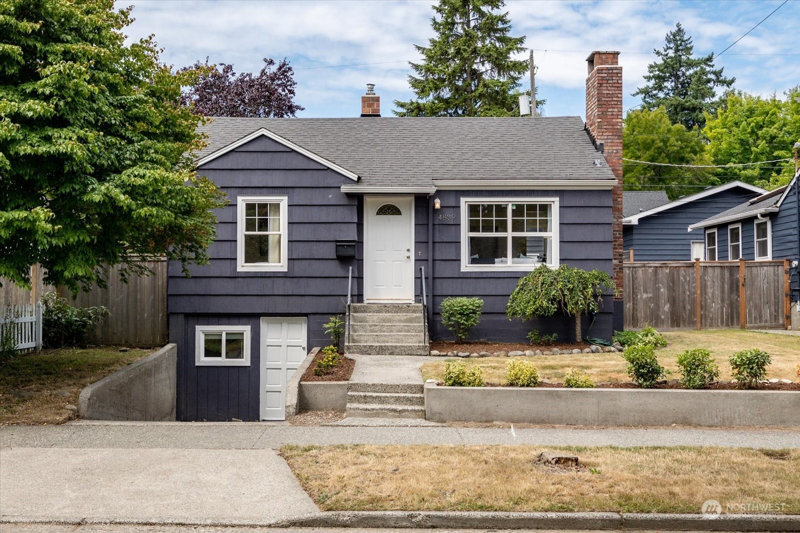 4839 50th Avenue Southwest Seattle, WA 98116 - Photo 1 of 31 front view of a house with a yard
