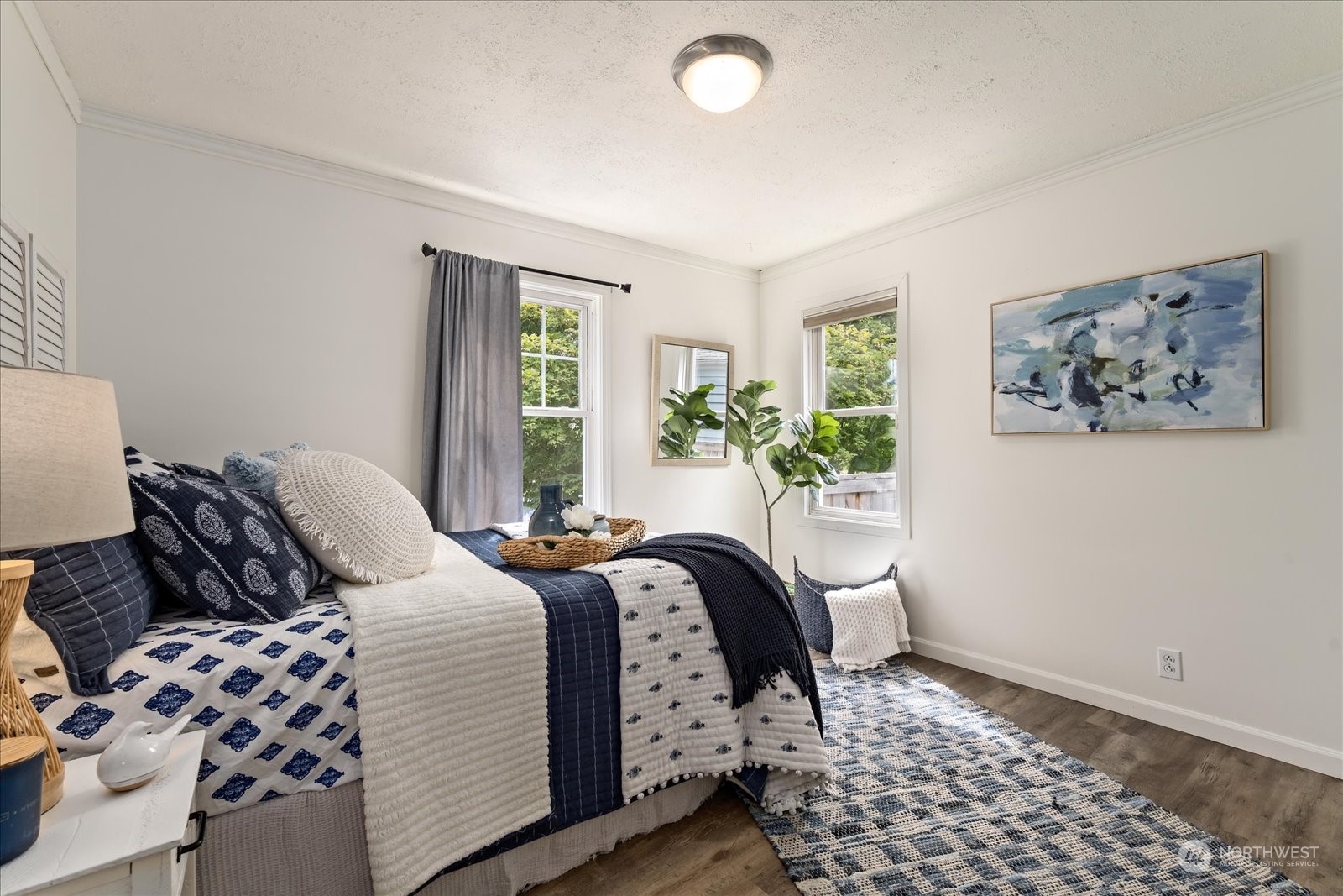 4839 50th Avenue Southwest Seattle, WA 98116 - Photo 16 of 31 a bedroom with bed and wooden floor