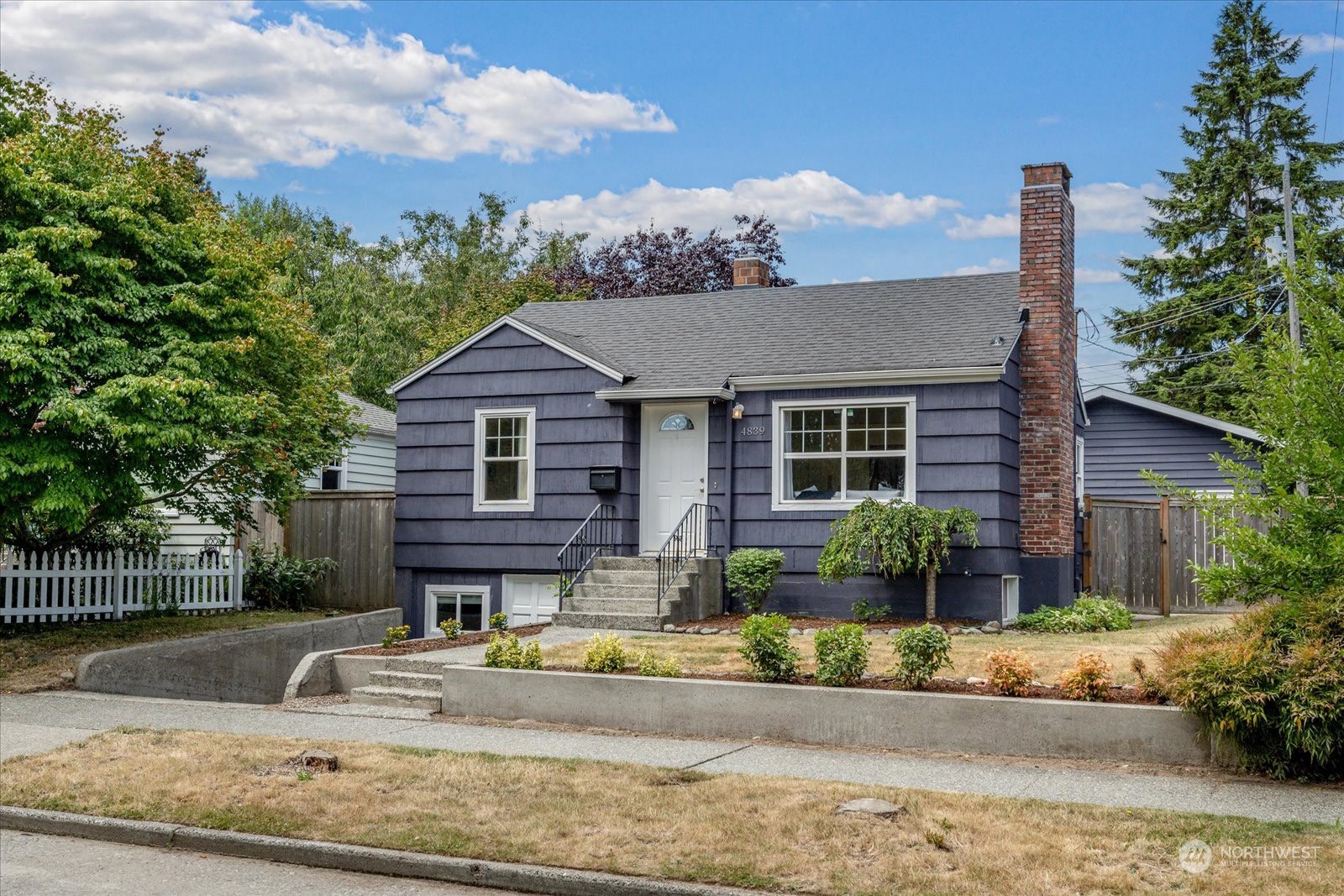 4839 50th Avenue Southwest Seattle, WA 98116 - Photo 2 of 31 a front view of a house with garden