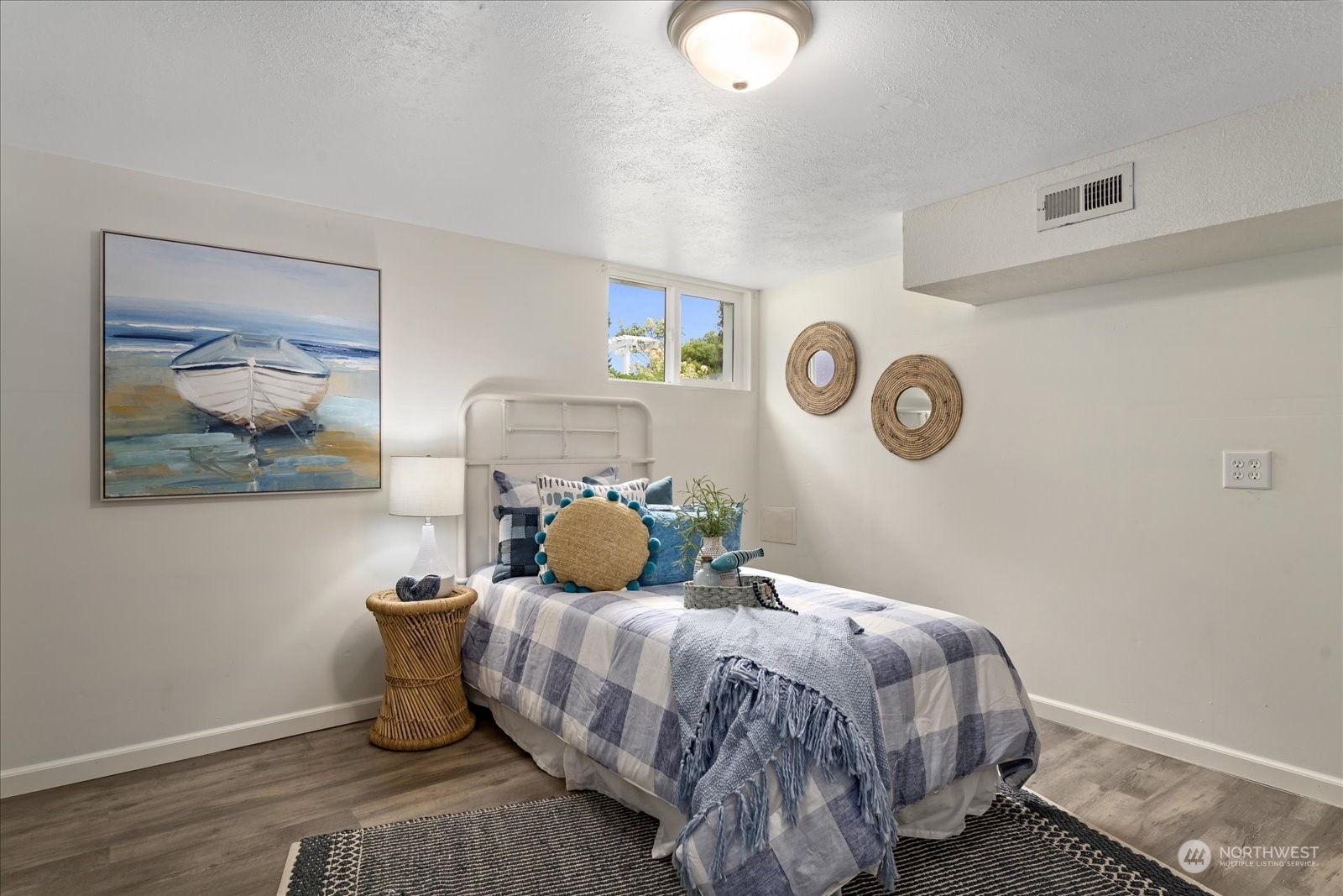 4839 50th Avenue Southwest Seattle, WA 98116 - Photo 21 of 31 a bedroom with a bed and painting on the wall
