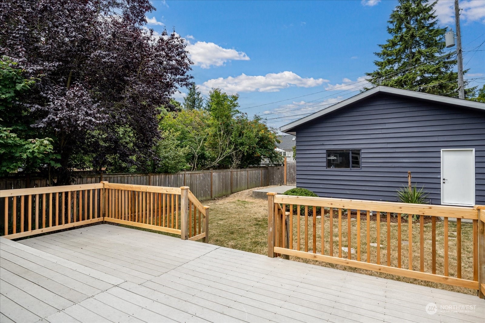 4839 50th Avenue Southwest Seattle, WA 98116 - Photo 24 of 31 a view of a house with a wooden deck