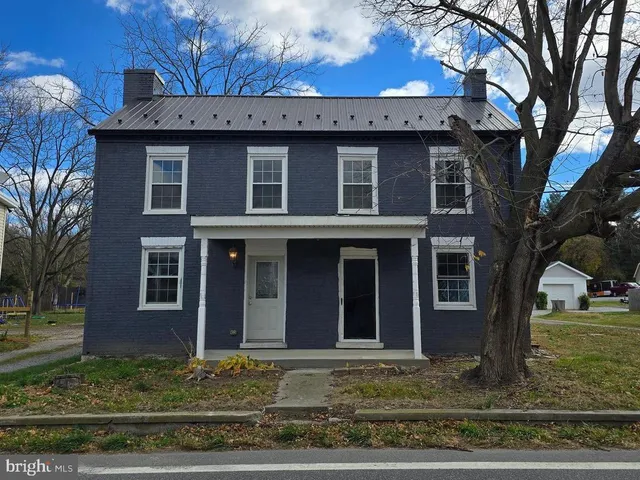 a view of a brick house with a large windows