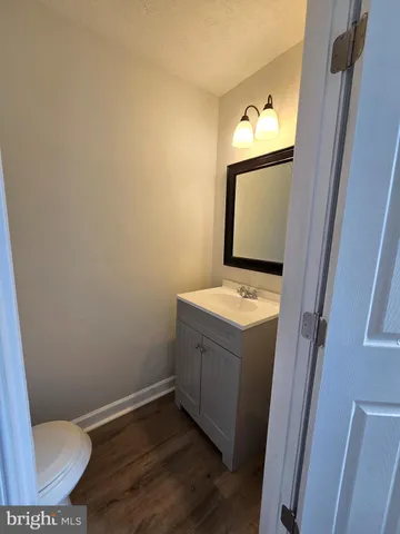 a bathroom with a sink and mirror with toilet