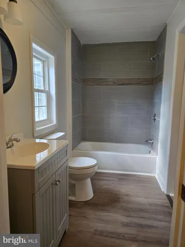 a bathroom with a sink a toilet and a bathtub