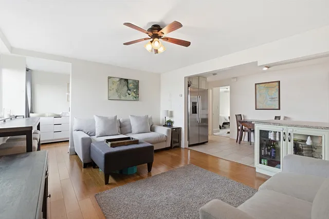 a living room with furniture and a dining table