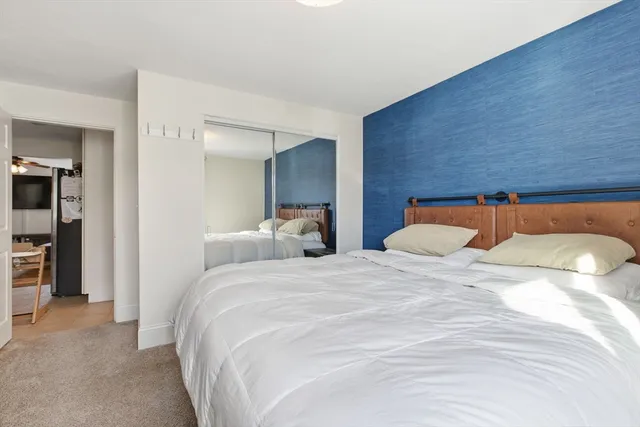 a bedroom with a bed and a view of bedroom