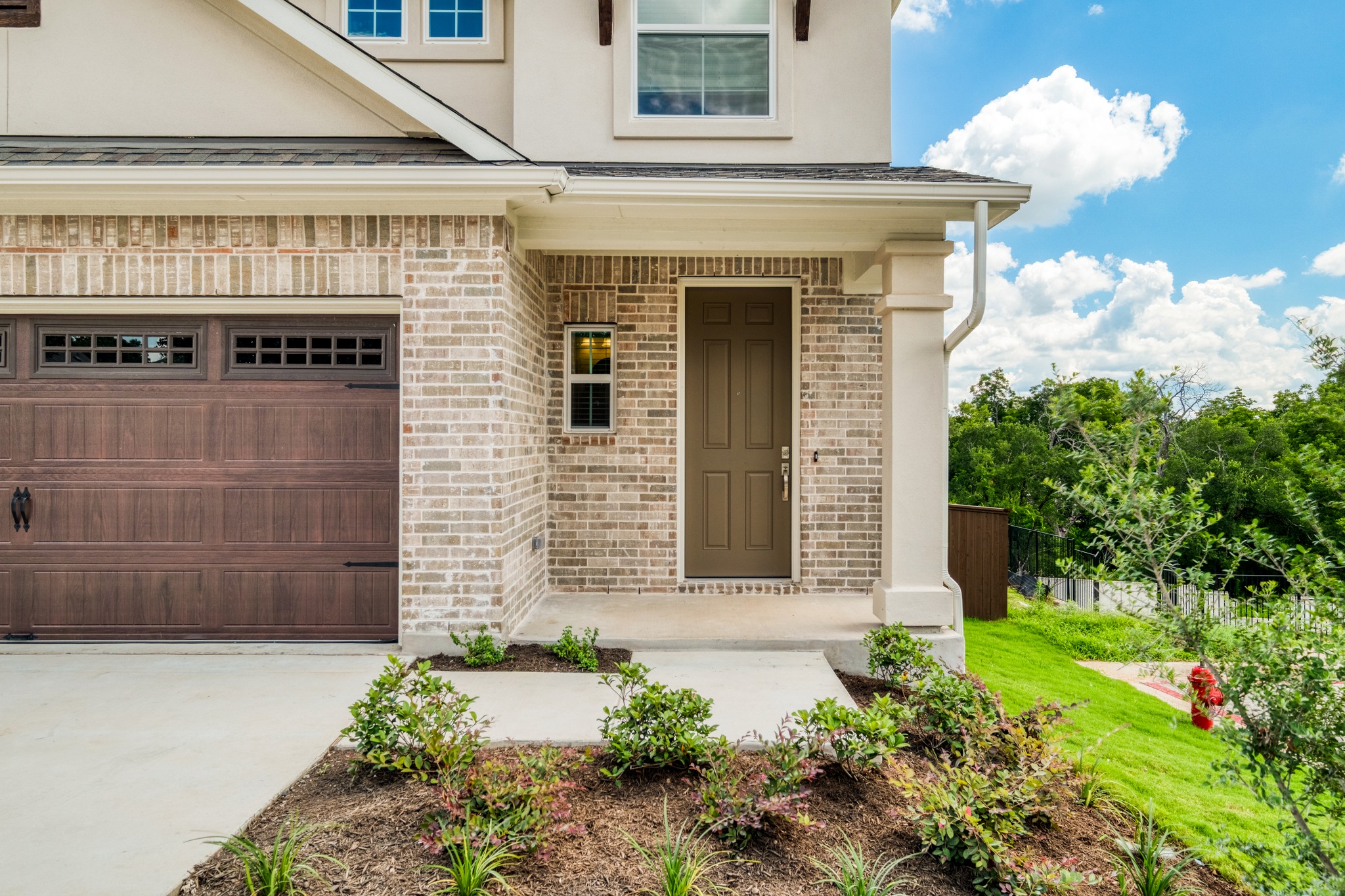 2605 Sam Bass Road, Unit 44 Round Rock, TX 78681 - Photo 4 of 26 A welcoming brick facade with a prominent front door and attached garage, offering delightful curb appeal. Neighbors on one side only.