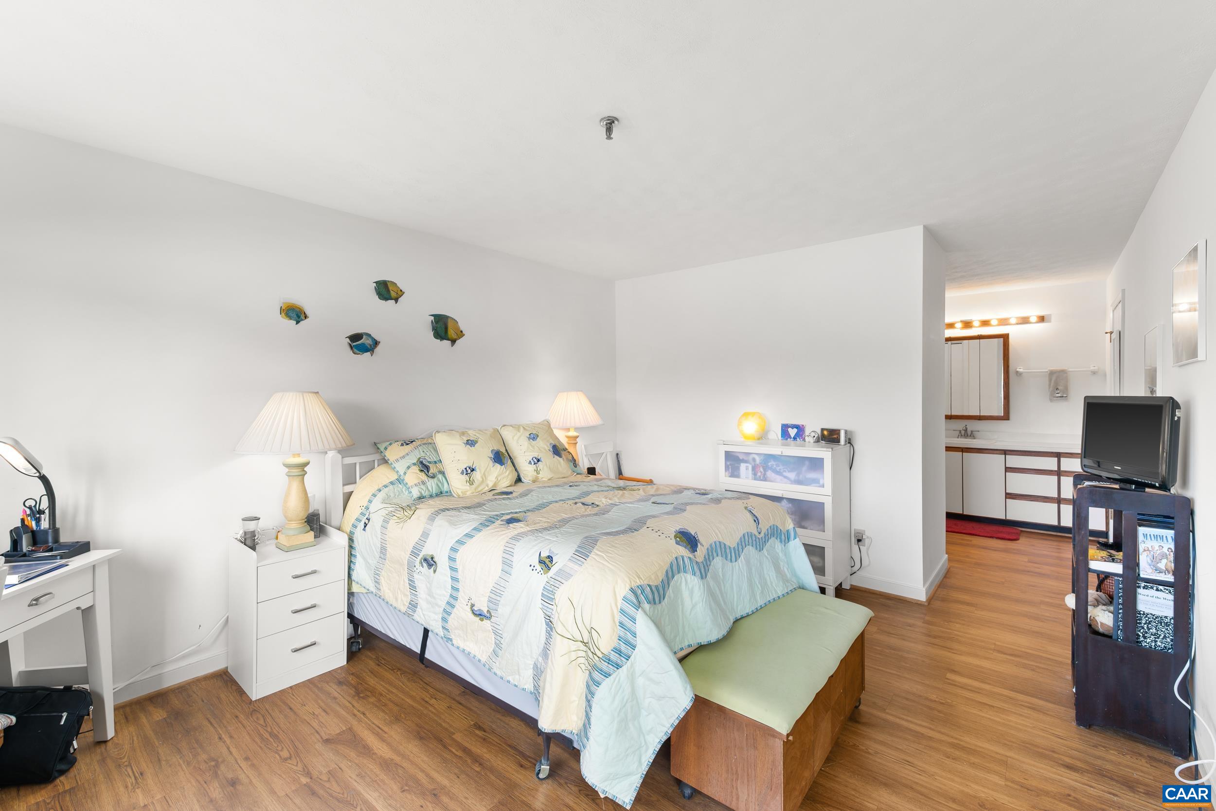 C2 Marina Point Palmyra, VA 22963 - Photo 19 of 27 a bedroom with a bed and wooden floor