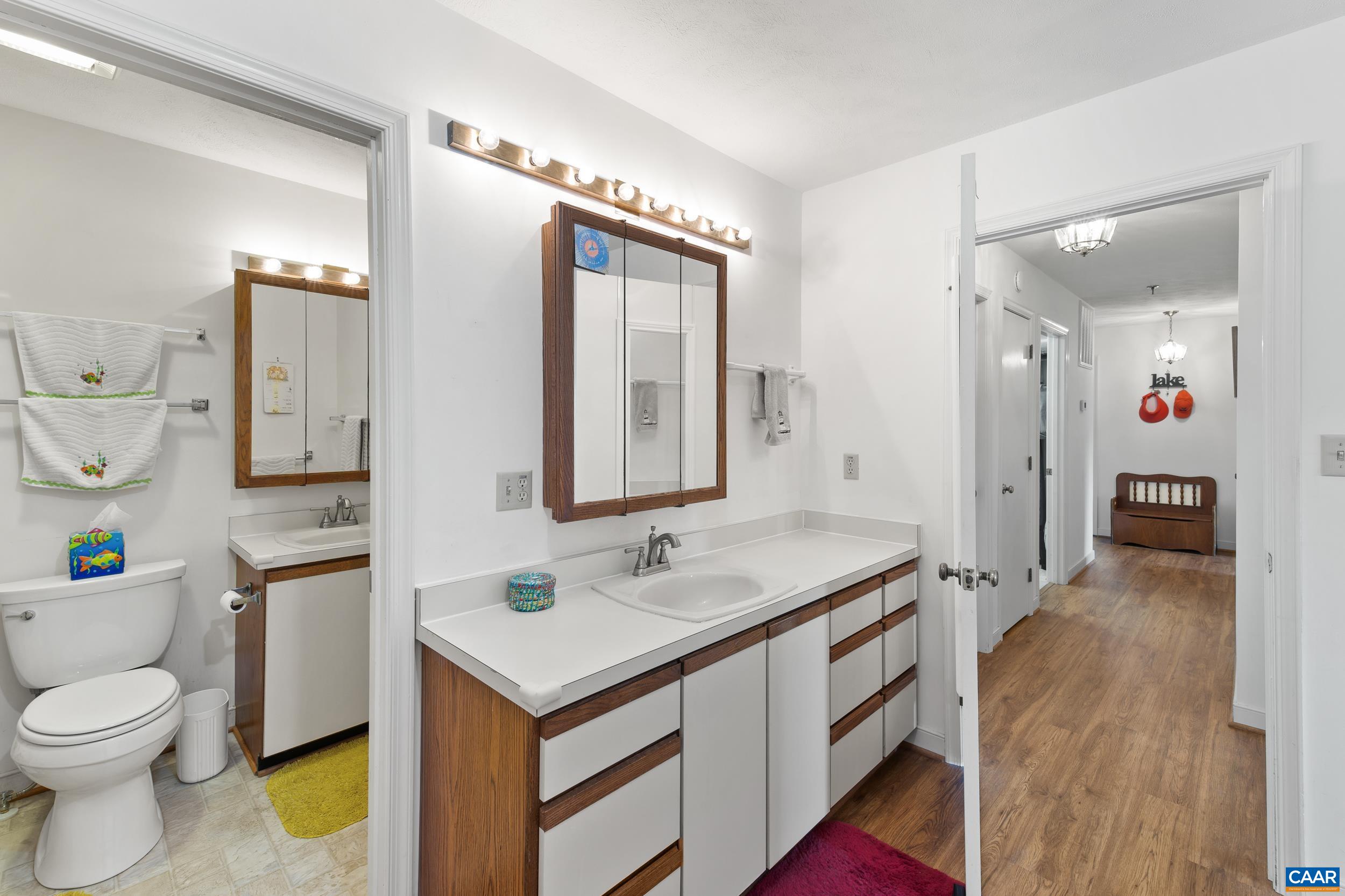 C2 Marina Point Palmyra, VA 22963 - Photo 20 of 27 a spacious bathroom with a granite countertop sink a toilet and a mirror