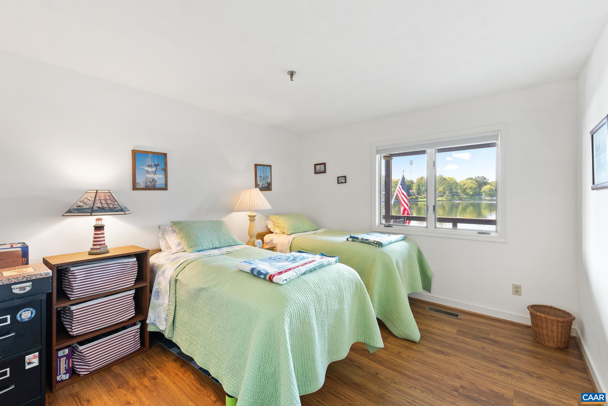 C2 Marina Point Palmyra, VA 22963 - Photo 21 of 27 a bedroom with a bed and a wooden floor