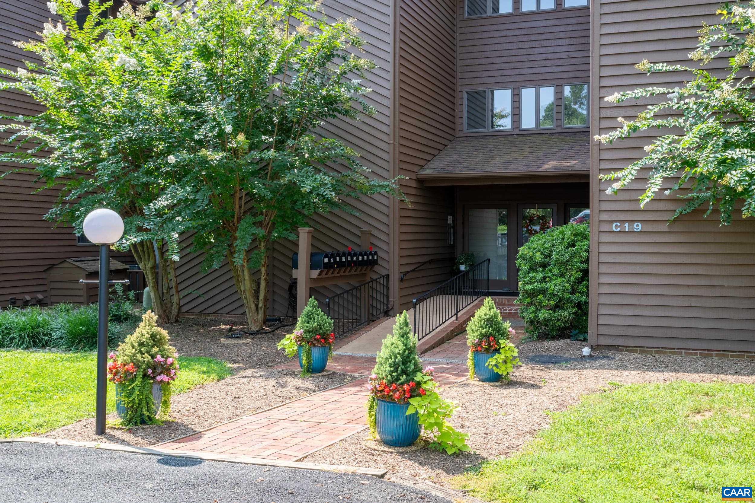 C2 Marina Point Palmyra, VA 22963 - Photo 7 of 27 a front view of a house with a yard and potted plants