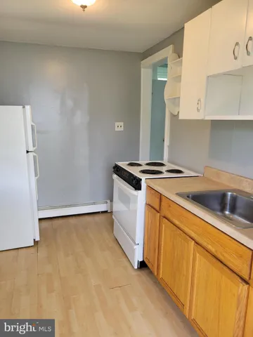 a view of an empty room with closet and a window