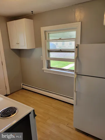 a white stove top oven sitting inside of a kitchen