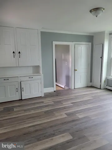 a view of a room with wooden floor and closet