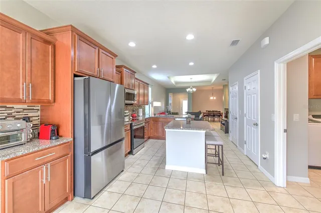 a kitchen with stainless steel appliances a refrigerator and a stove top oven