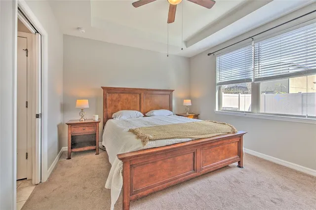 a bed sitting in a bedroom next to a window