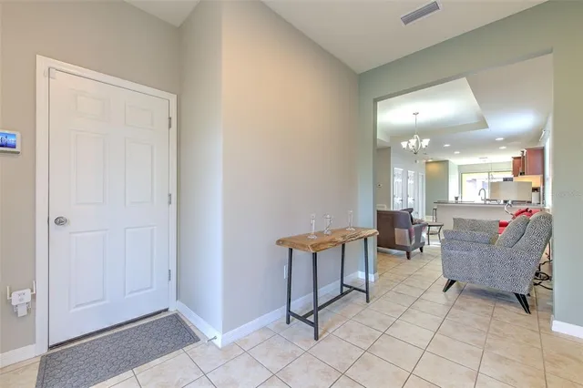 a living room with couches and a dining table with wooden floor