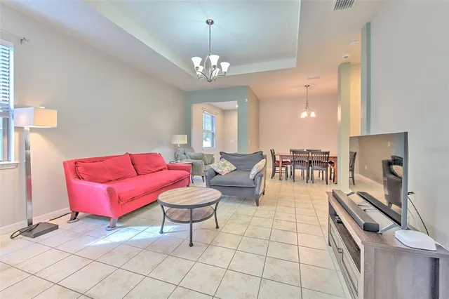 a living room with furniture and a chandelier